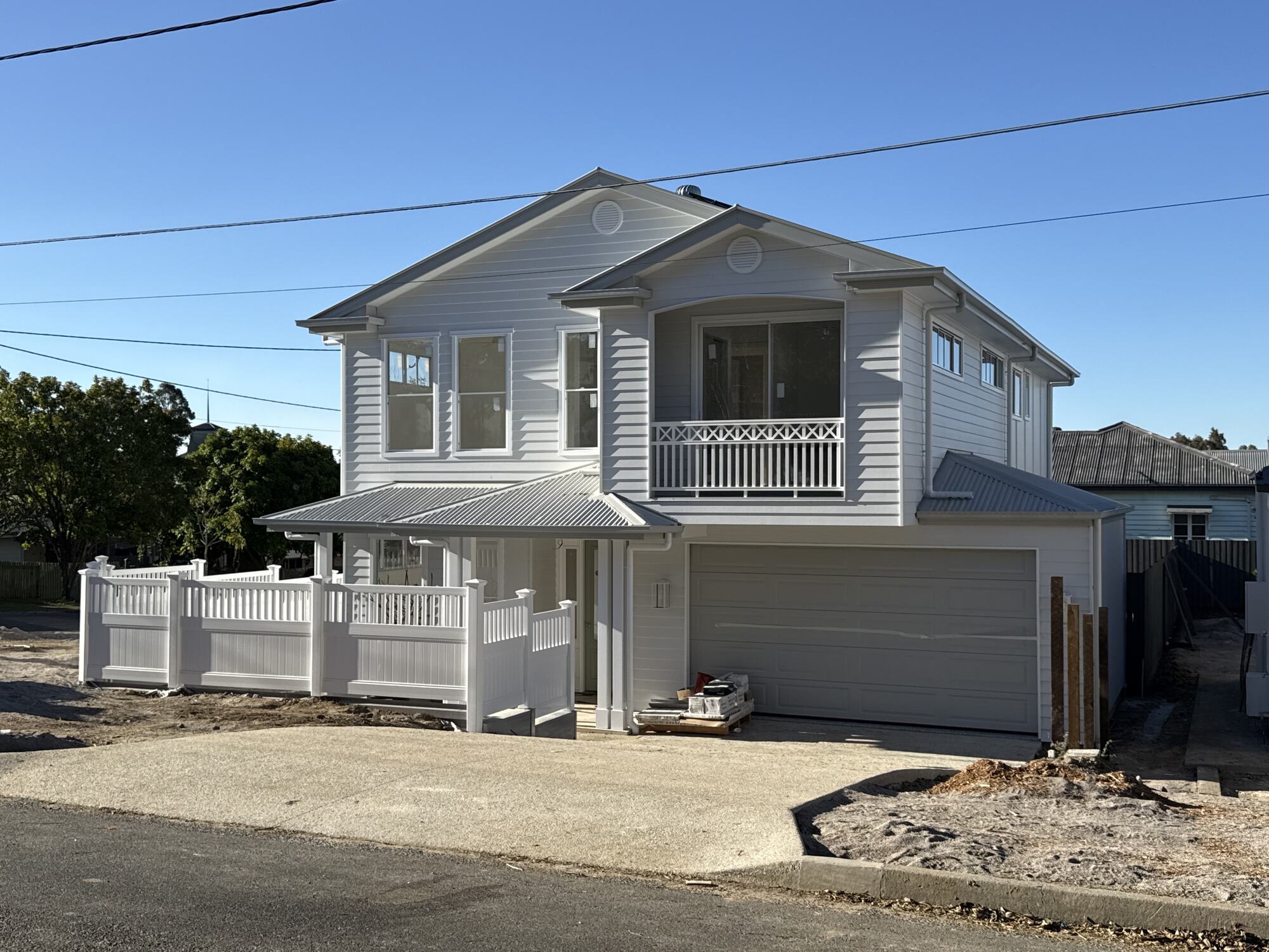 Near-complete two-storey weatherboard home on a Brisbane development site